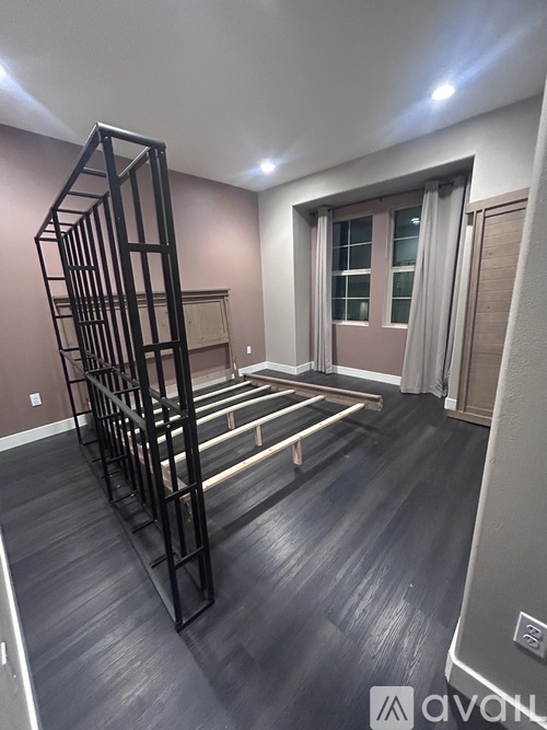 A room with a spiral staircase and wooden flooring.