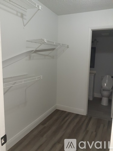 A small, empty room with a toilet in the background.