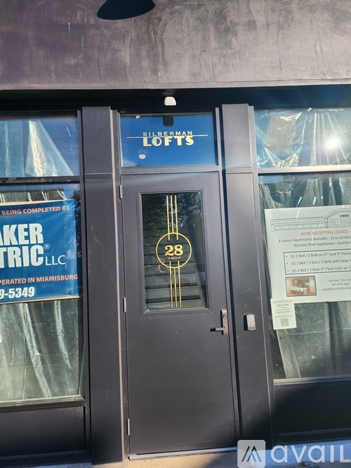 The door to a building with a sign that says "Silverman Lofts" above it.