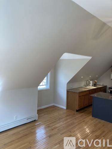 A room with wooden floors and a window.