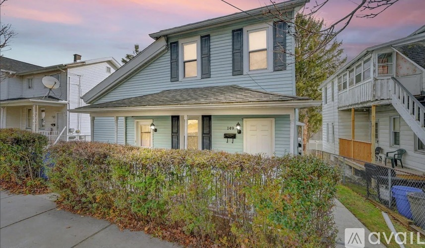 A house with a blue front door is available for rent.