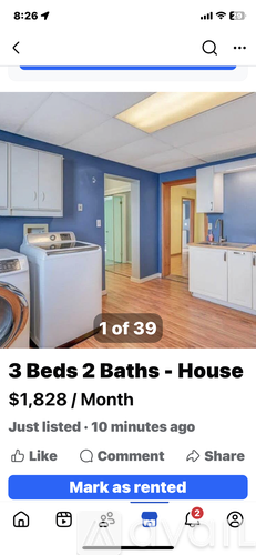 A house rental listing shows a kitchen with white cabinets and a blue wall.