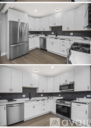 A modern kitchen with white cabinets and stainless steel appliances.