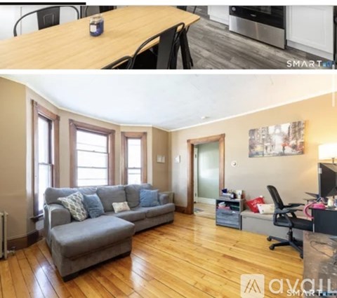 A living room with a grey couch and a wooden table.