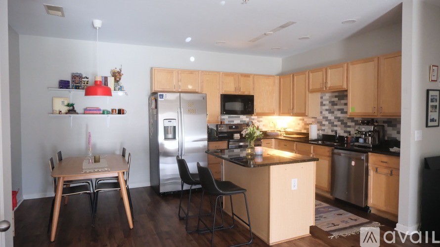 A kitchen with wooden cabinets and a refrigerator.