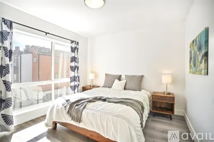 A bedroom with a large bed and a view of the city.