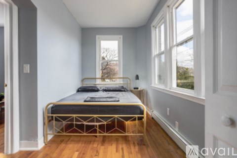 A bedroom with a bed and a window.