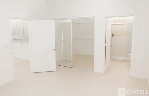 A white room with three open doors.