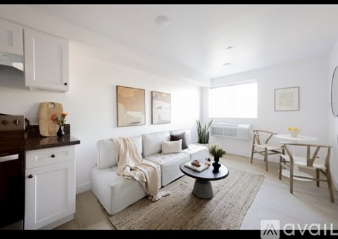 A living room with a white couch and a coffee table.