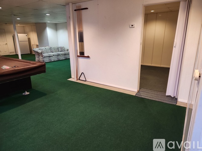 A room with a pool table and a couch.