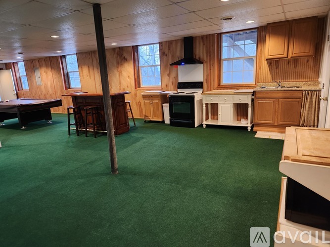 A room with a green floor and wooden walls.