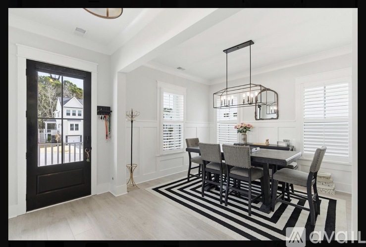 A dining room with a table set for four.