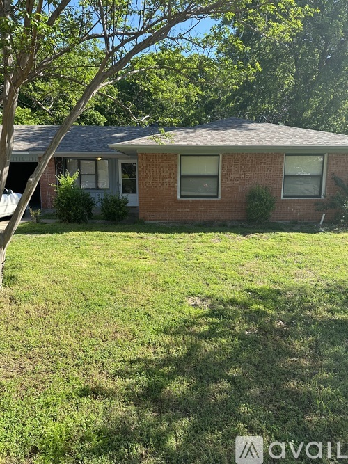 A house with a lawn in front of it.