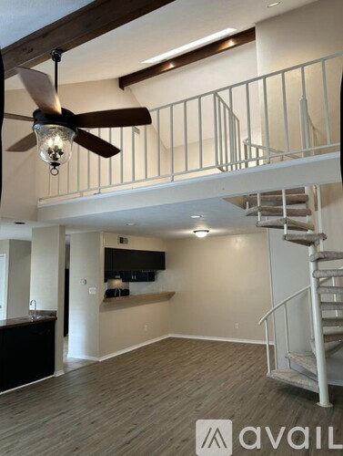 A modern living room with a staircase leading to the upper level.