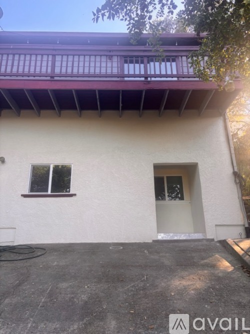 A house with a white exterior and a purple roof.