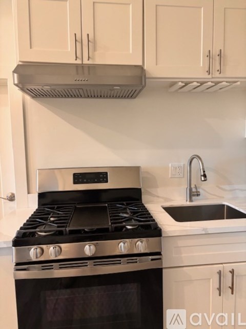 A modern kitchen with a stove and sink.