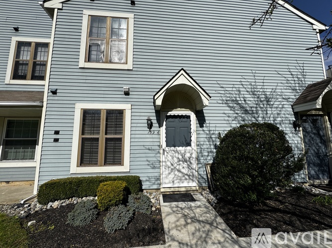 A house with a white door and windows is shown.