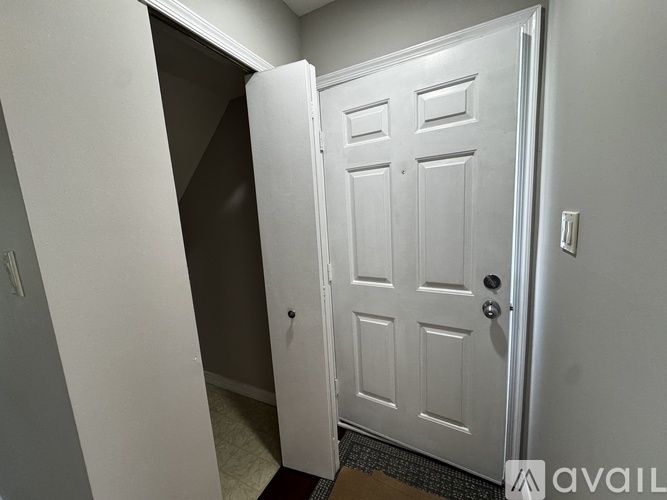 A white door is open to a hallway.