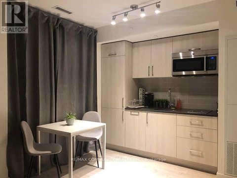 A modern kitchen with a table and chairs.