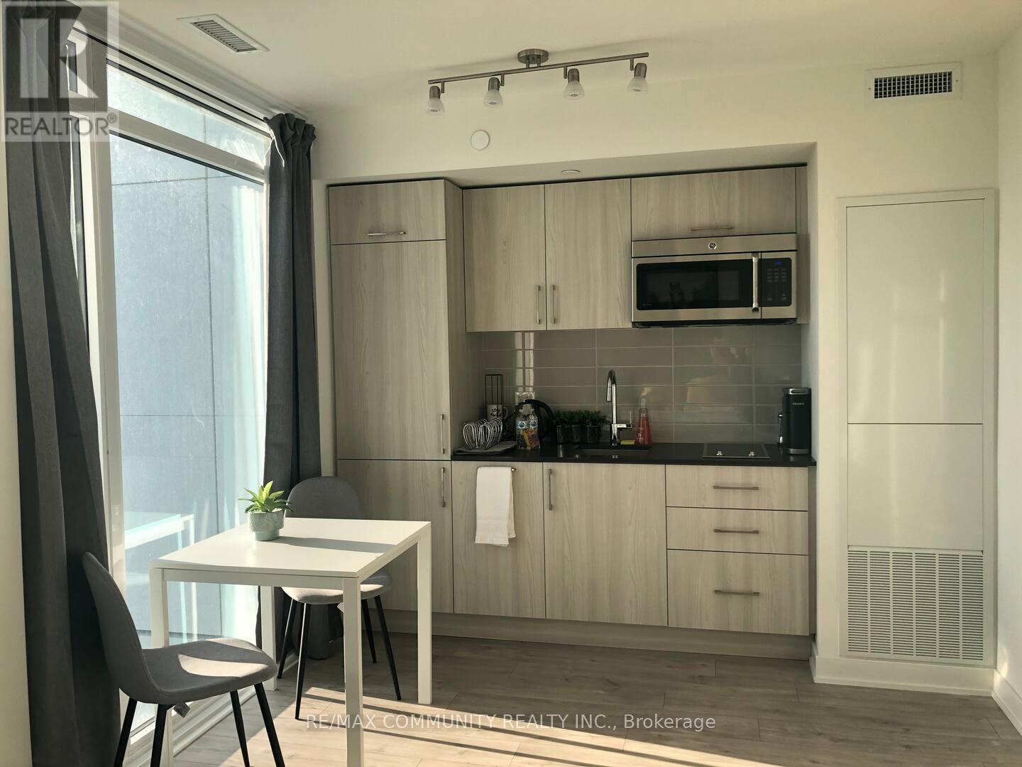 A modern kitchen with a dining table and chairs.