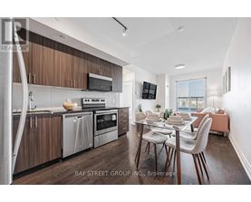 A modern kitchen with wooden cabinets and stainless steel appliances.