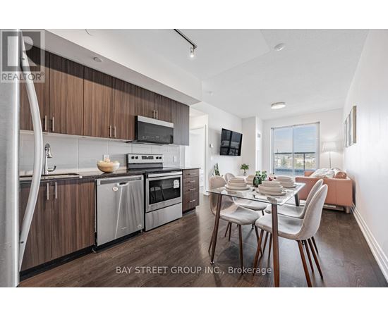 A modern kitchen with wooden cabinets and stainless steel appliances.