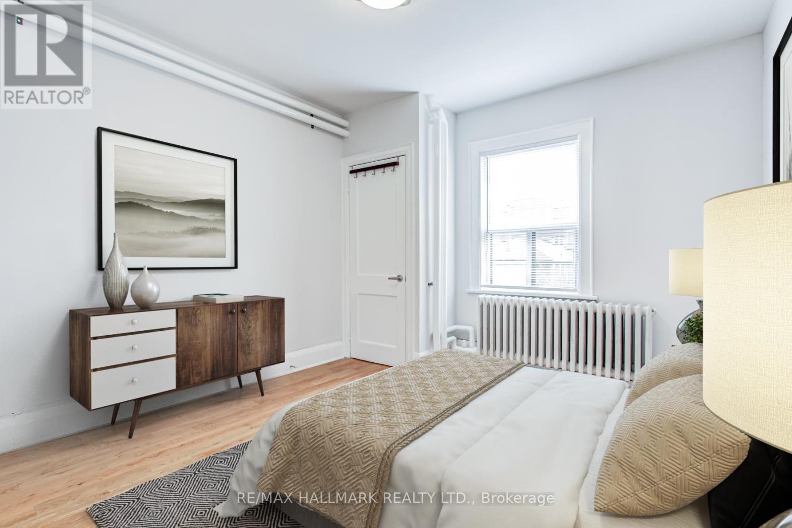 A bedroom with a bed, dresser, and mirror.