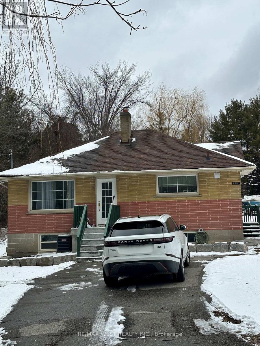 A house with a white car parked in front.