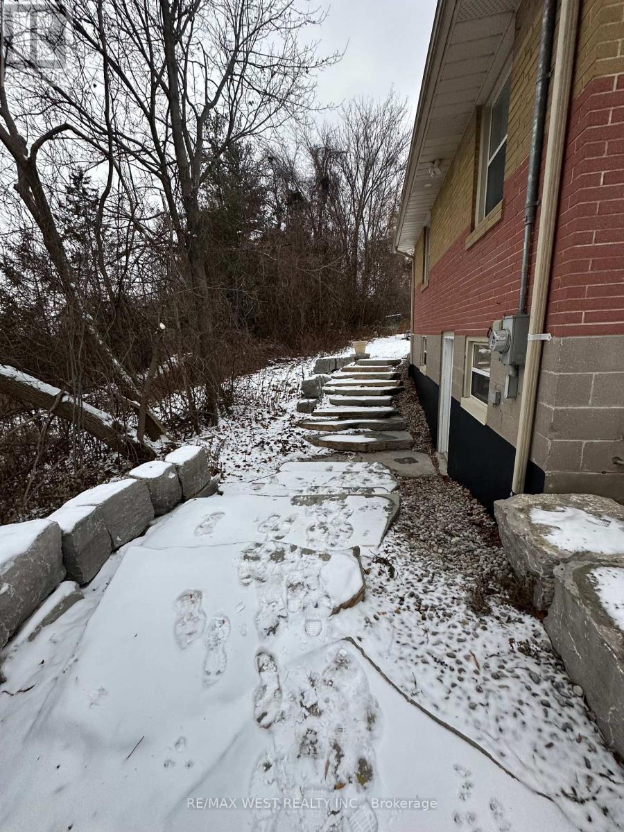 A snow-covered path leads to a house.