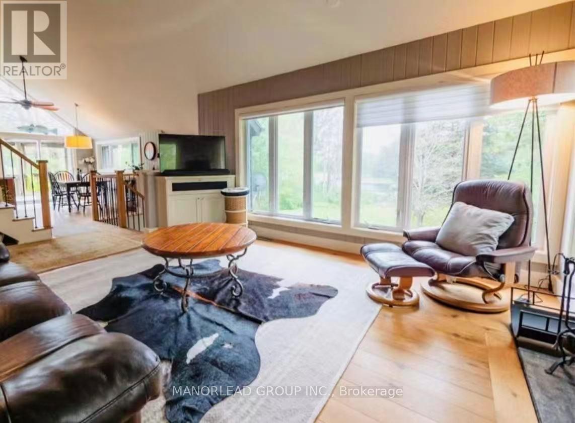 A living room with a brown leather couch and a wooden coffee table.