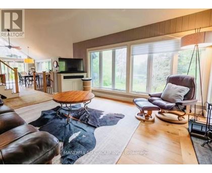 A living room with a brown leather couch and a wooden coffee table.