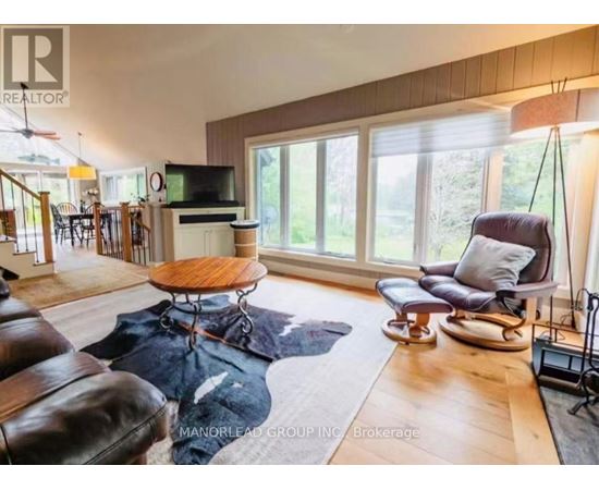 A living room with a brown leather couch and a wooden coffee table.