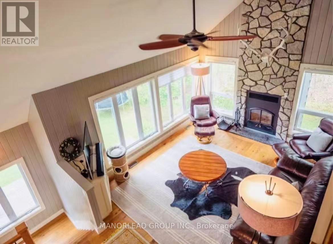 A living room with a fan, a couch, and a table.
