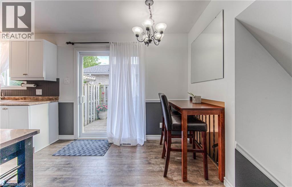 A dining room with a wooden table and chairs.