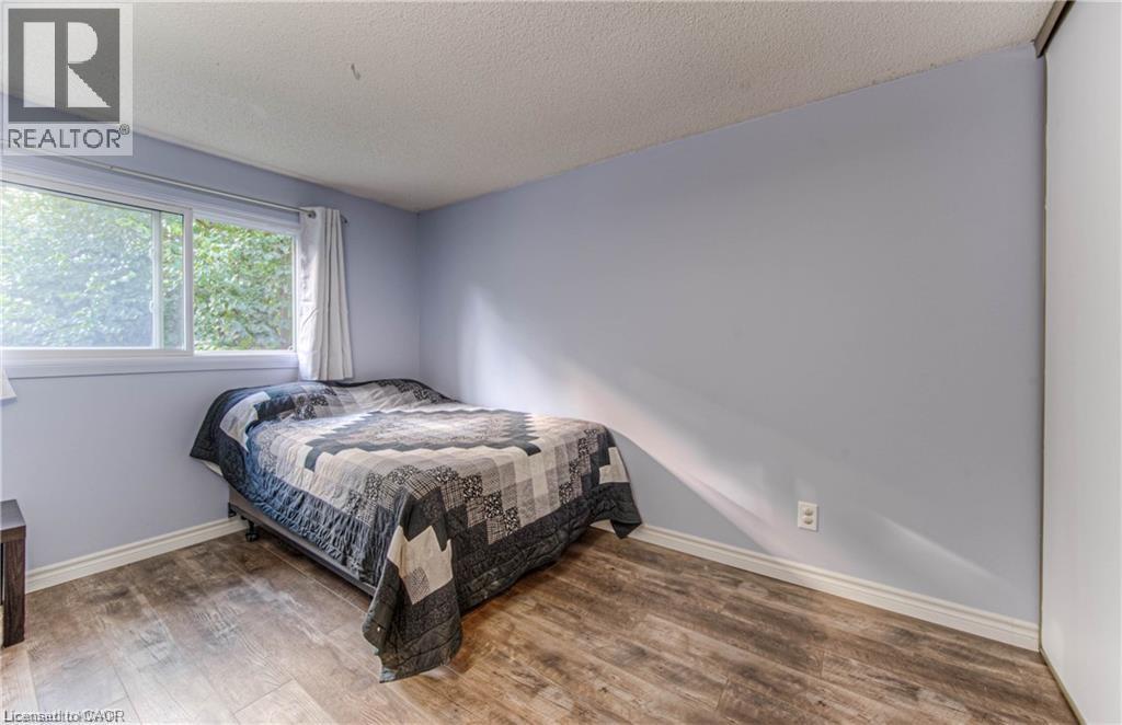 A bedroom with a bed and a window.