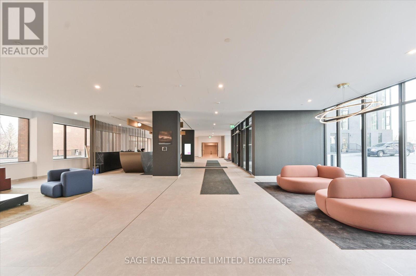 A spacious lobby with a reception desk and seating area.