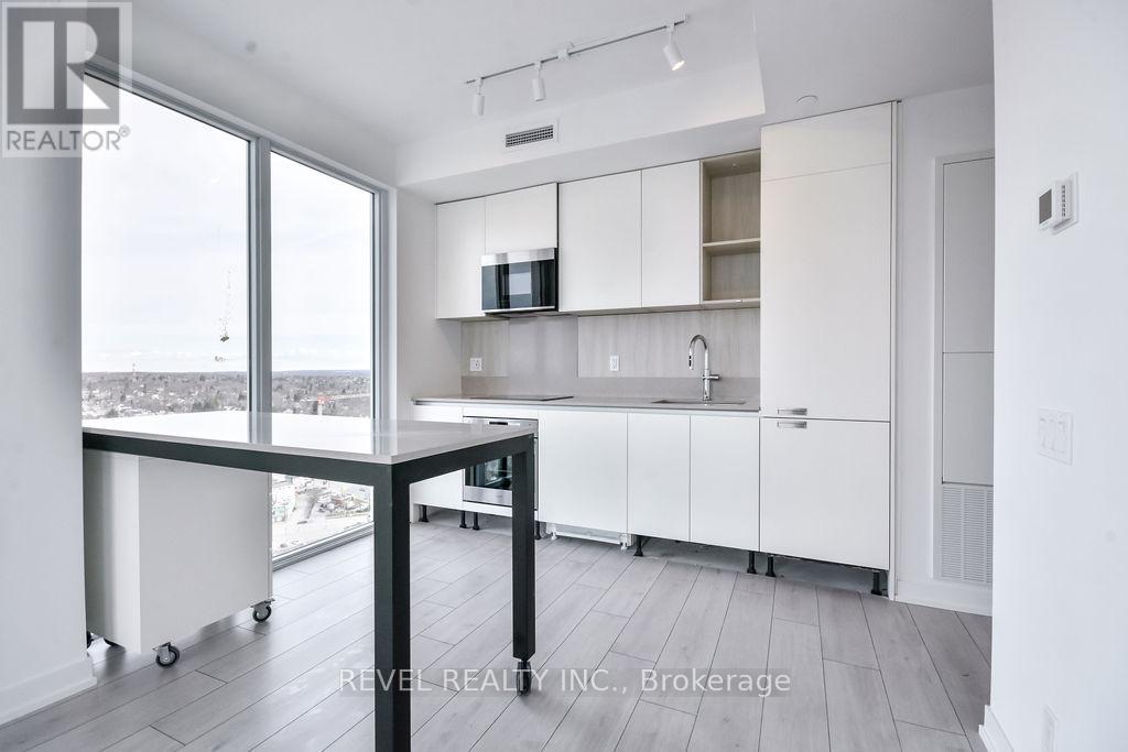 A kitchen with white cabinets and a black table.