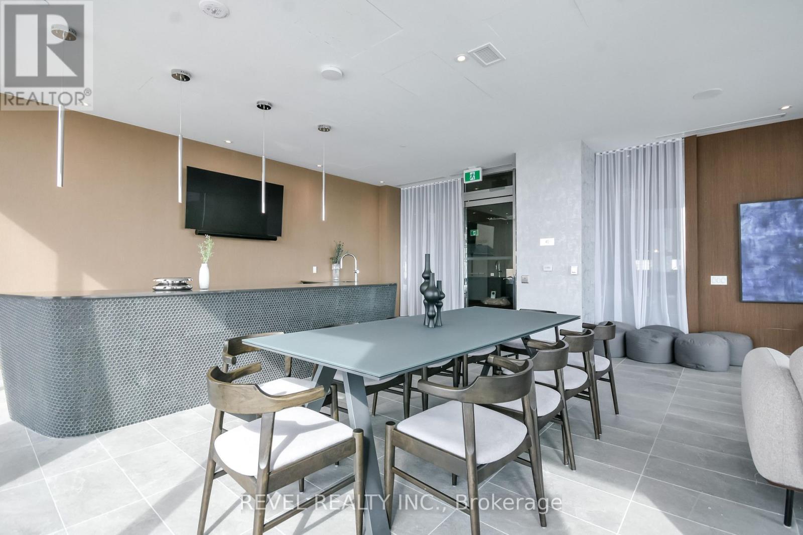 A modern dining room with a large table and chairs.