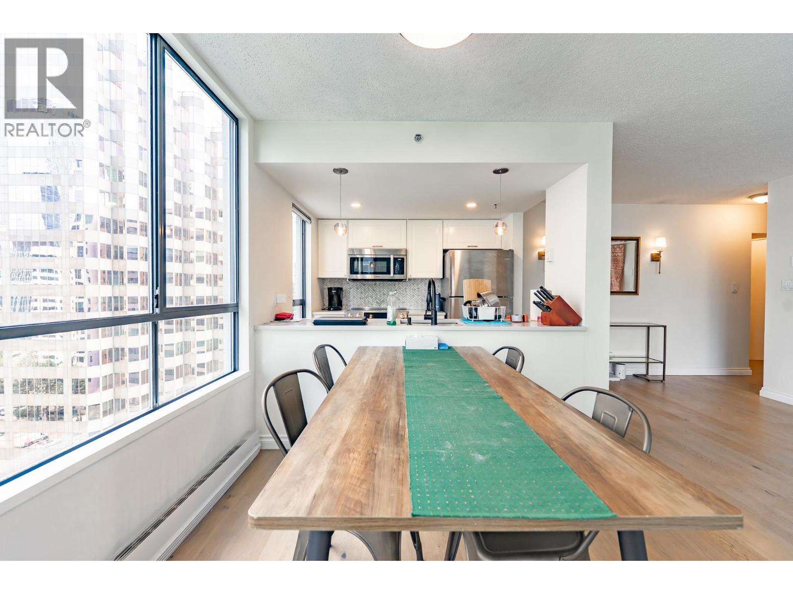 A dining room with a wooden table and chairs.