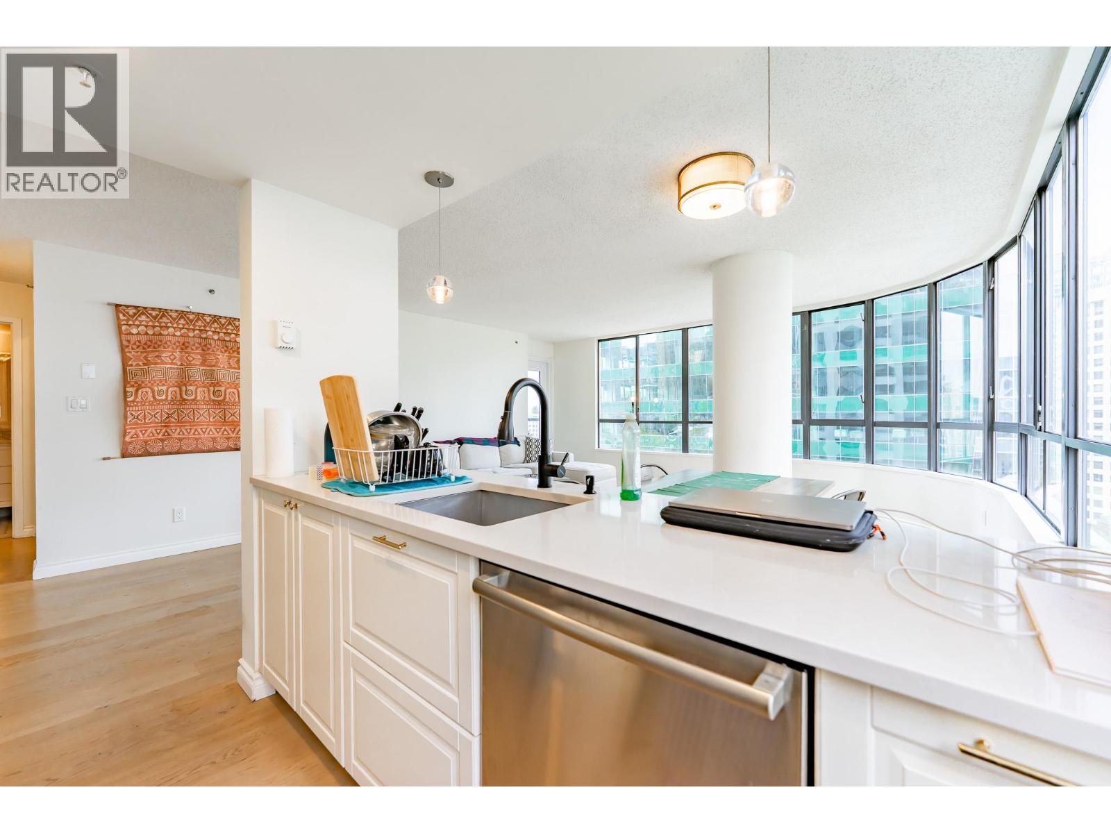A kitchen with a refrigerator covered in magnets.