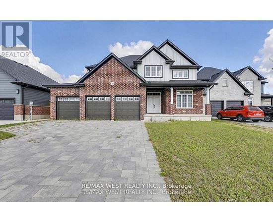 A house with a red car parked in front of it.