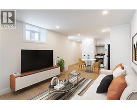 A living room with a television, a sofa, and a coffee table.