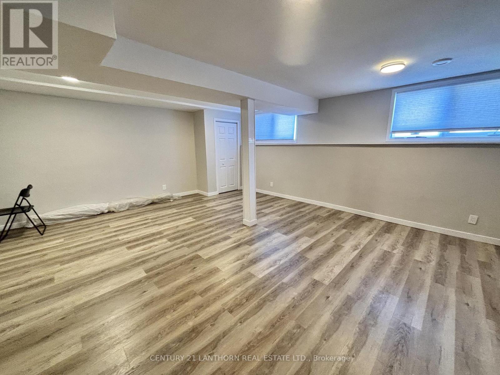 A room with wooden flooring and a white ceiling.