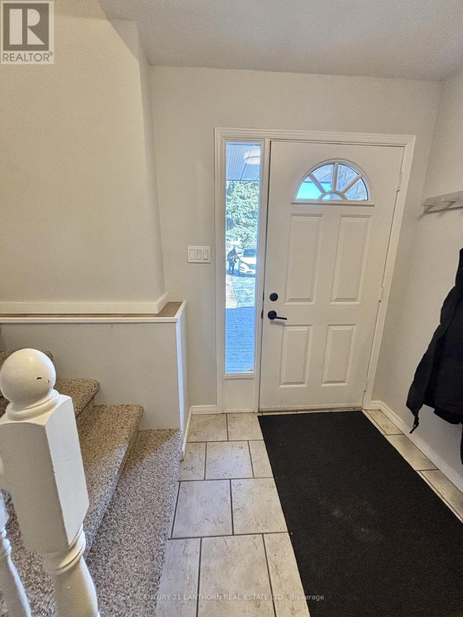 A white door with a window in the middle is in a room with a carpet.