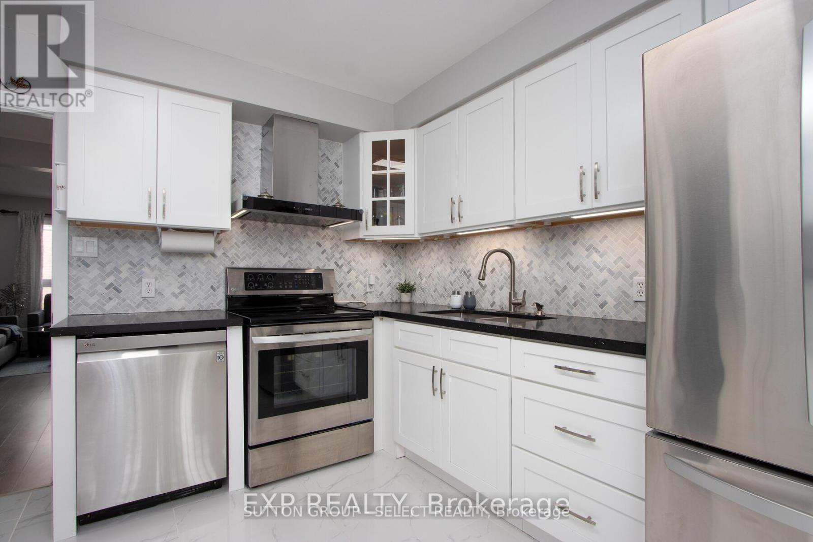 A kitchen with white cabinets and stainless steel appliances.