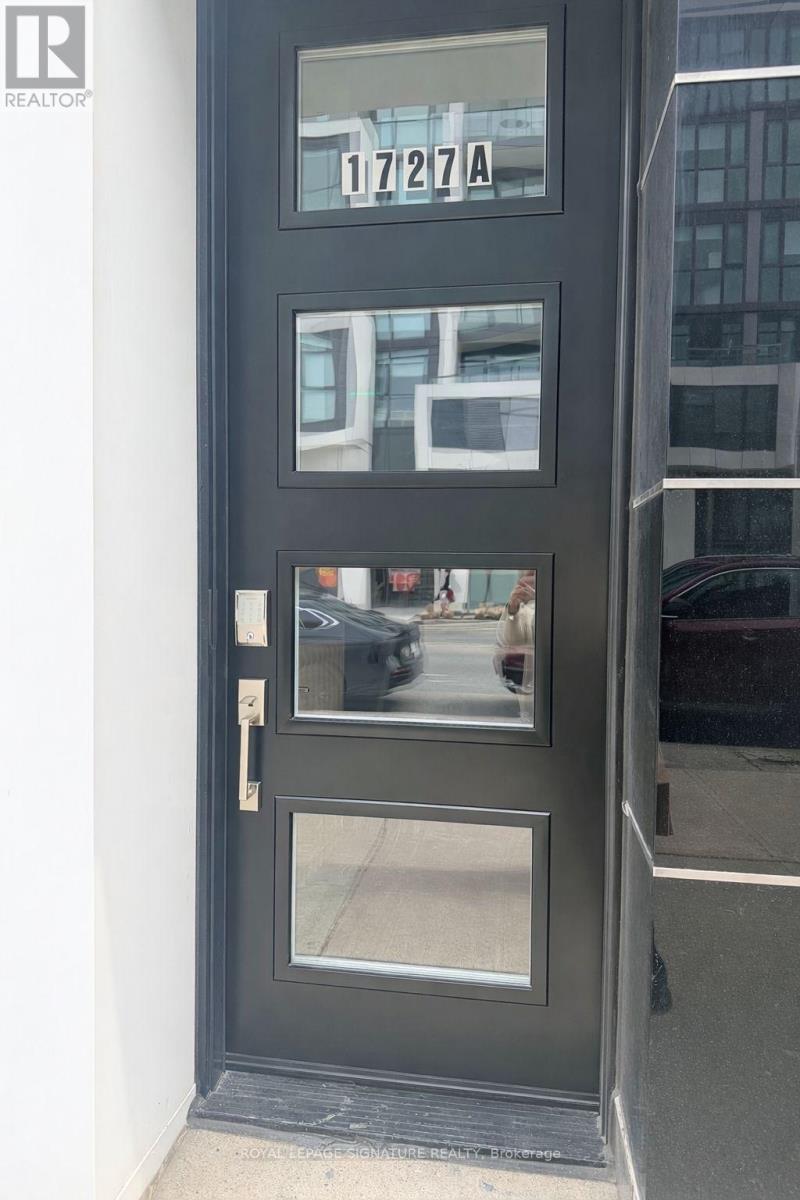A black door with a glass window and a metal handle.