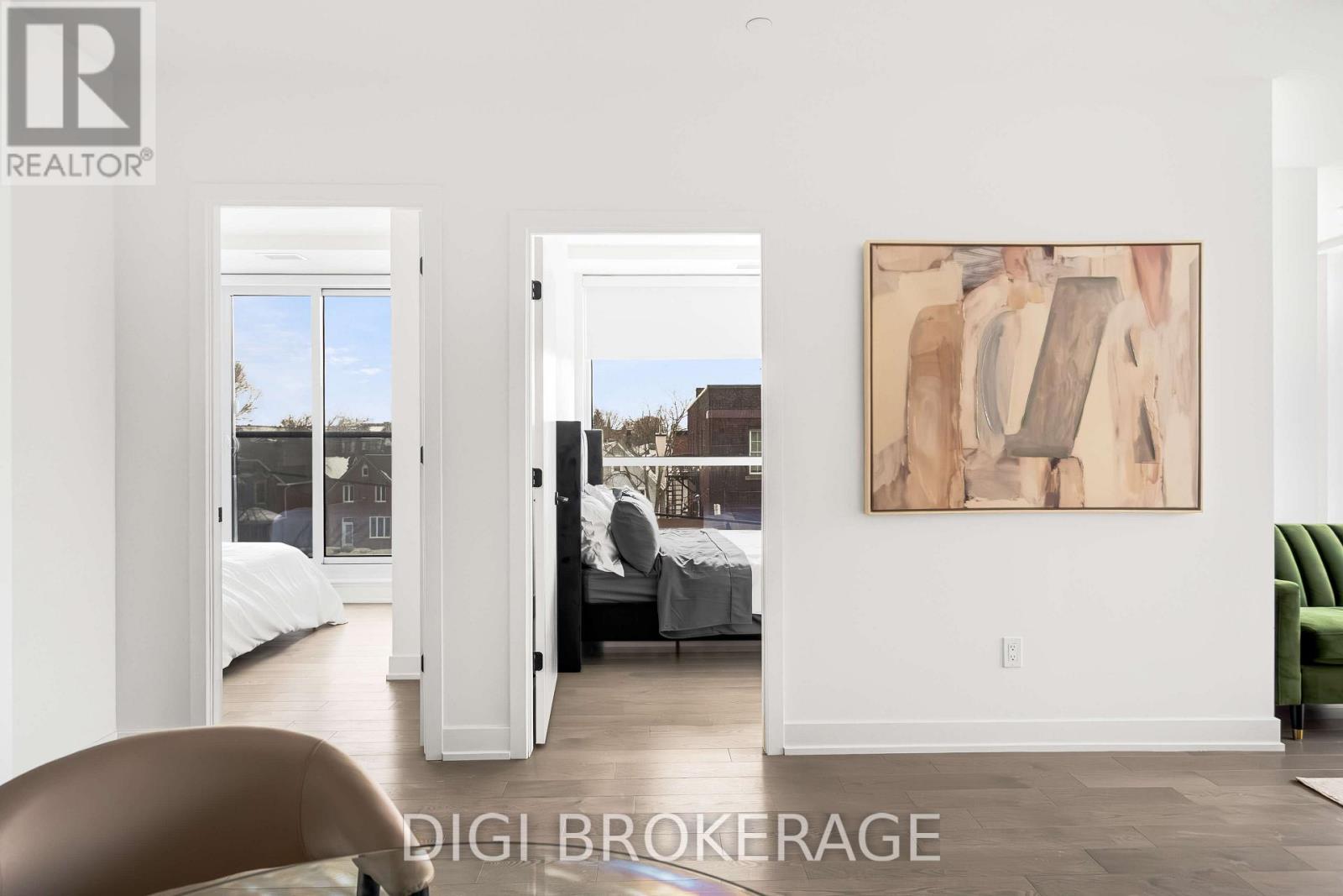 A bedroom with a large bed and a painting on the wall.
