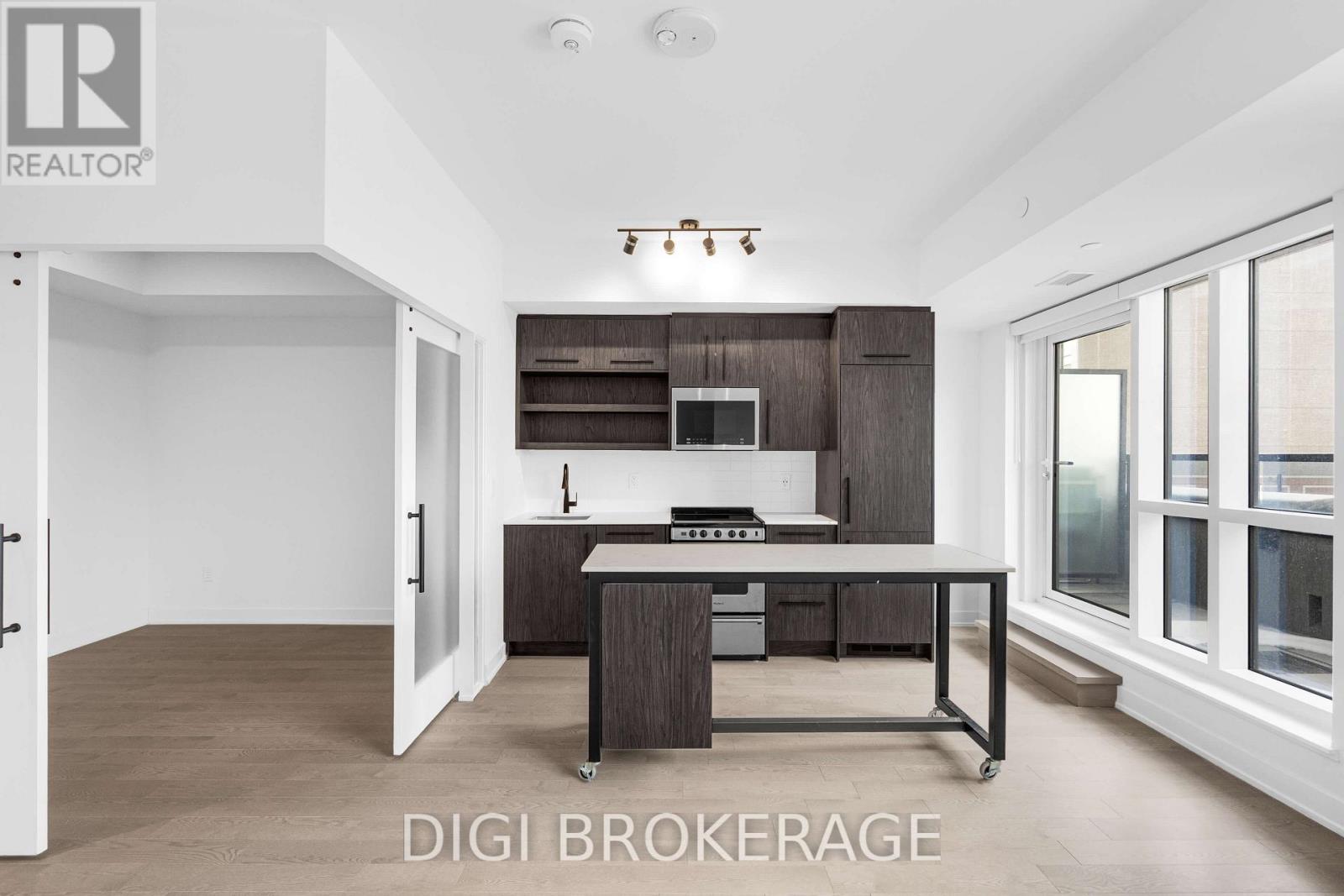 A modern kitchen with a dining table and chairs.