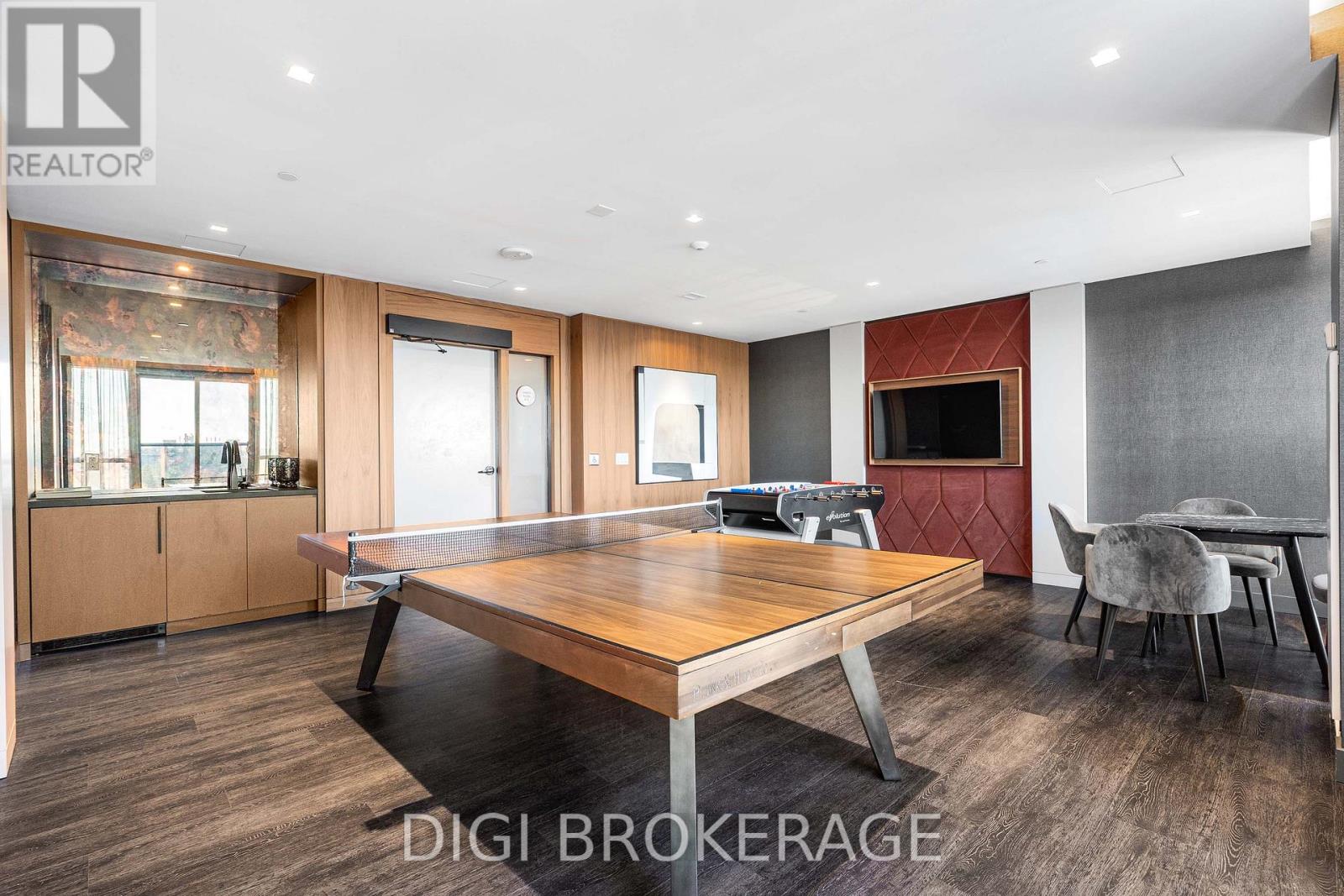 A room with a pool table and a tv.