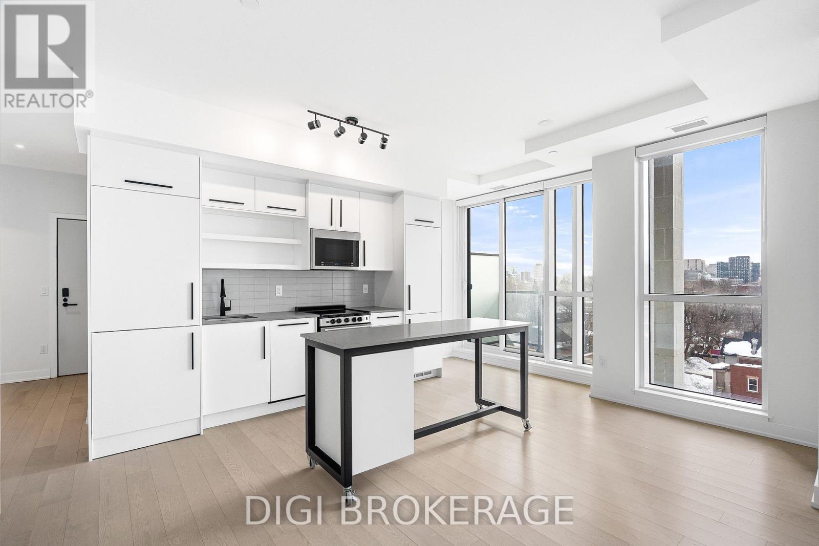 A modern kitchen with white cabinets and a central island.